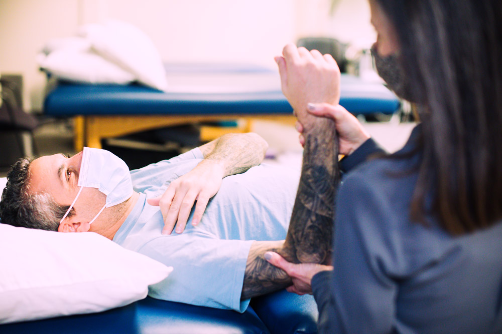 physical therapists helps patient