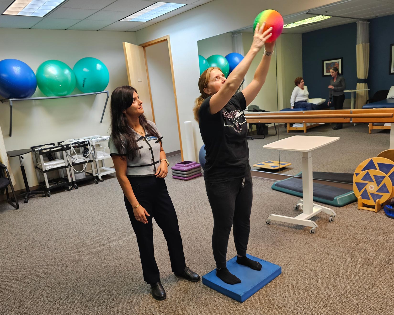 Divya Negi helps a patient with balance practice